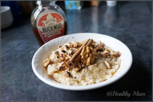 Vegan apple porridge topped with roasted walnuts and maple syrup