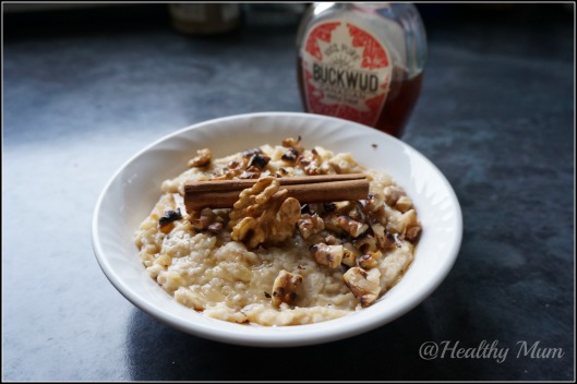 Vegan apple porridge topped with roasted walnuts and maple syrup